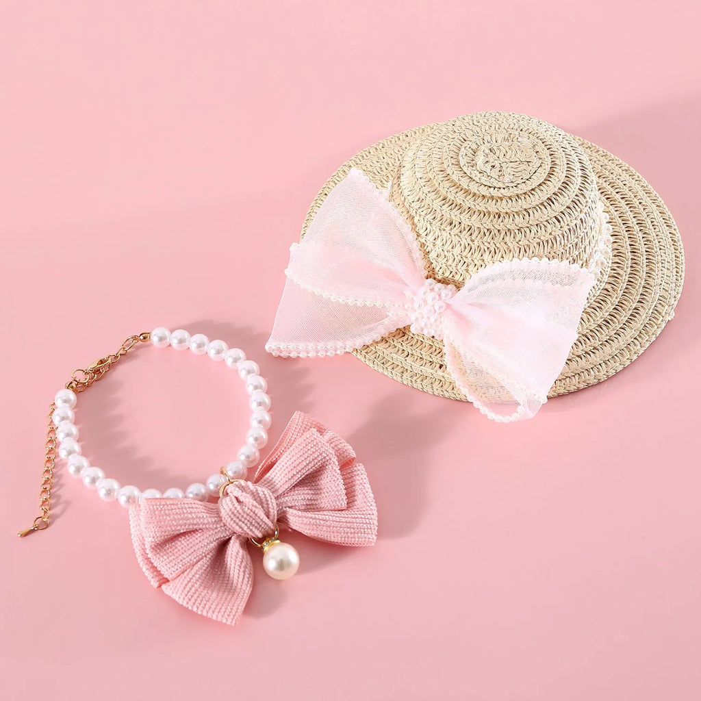 Woven straw hat with pearl bow decoration for cats, available in four colours and two sizes