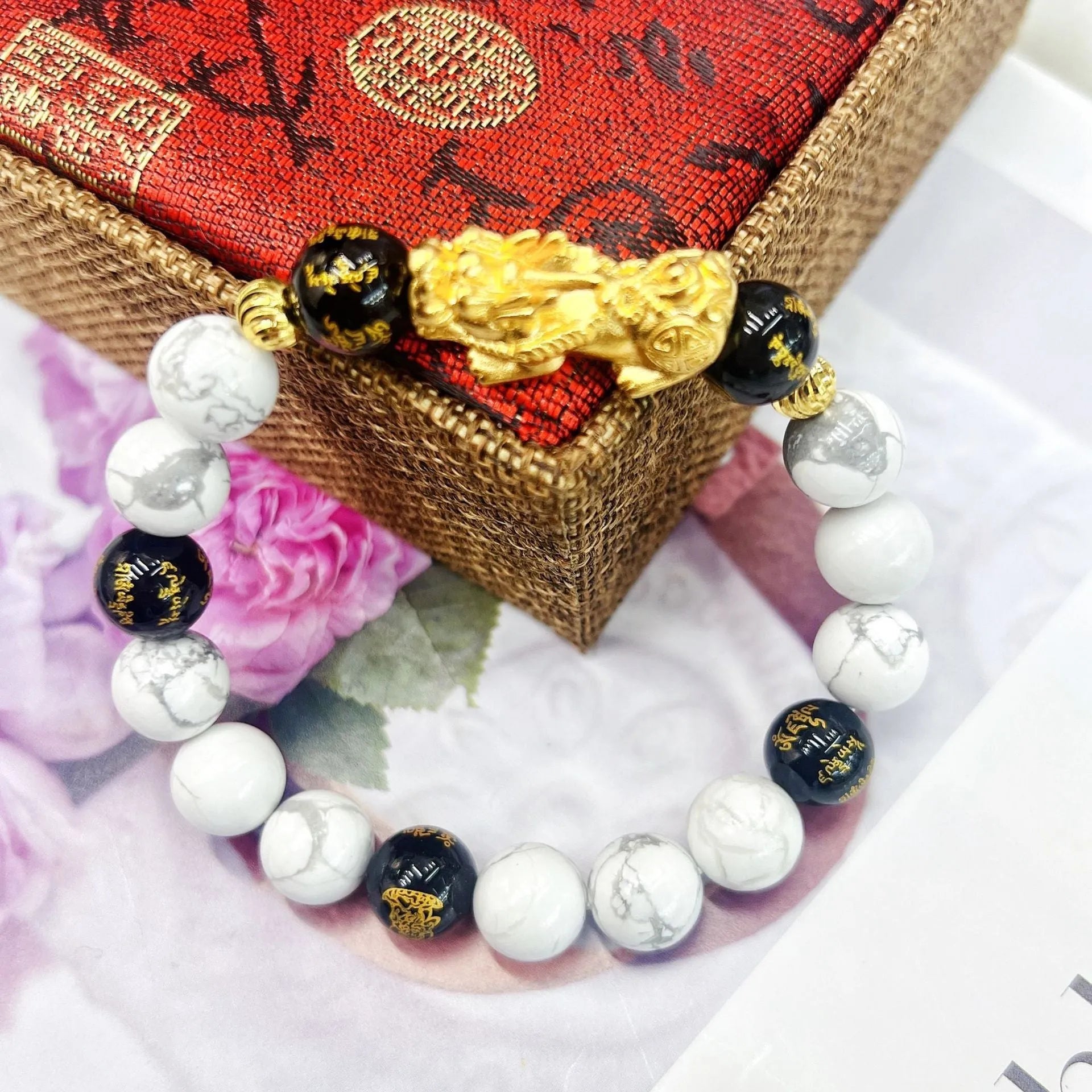 Vintage couple bracelet with white turquoise and black agate stones on a wrist.