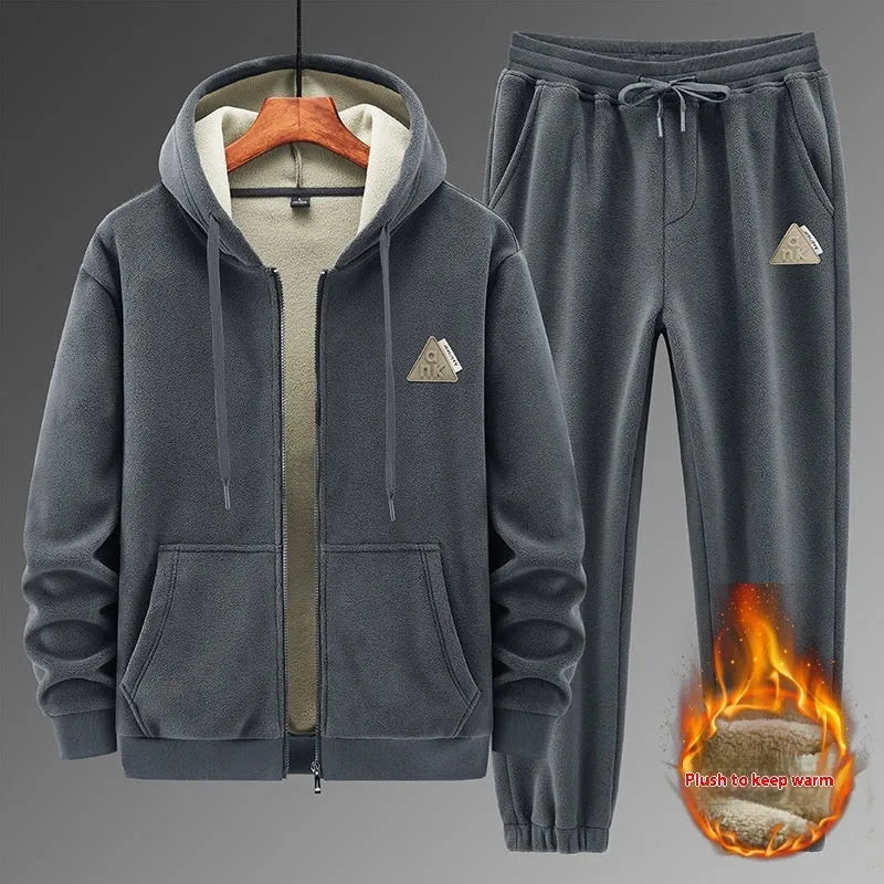 Man wearing a grey cashmere hooded sweater and matching cotton pants from a casual sports suit set.
