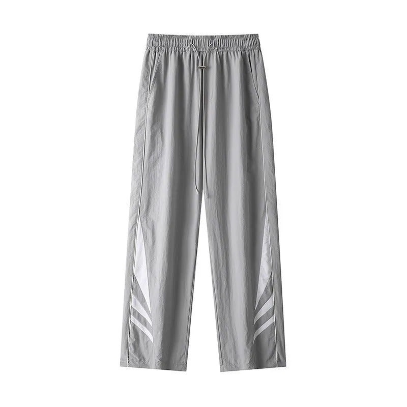 Men's loose fit straight-leg trousers in black, featuring an elasticated waist and button fly.