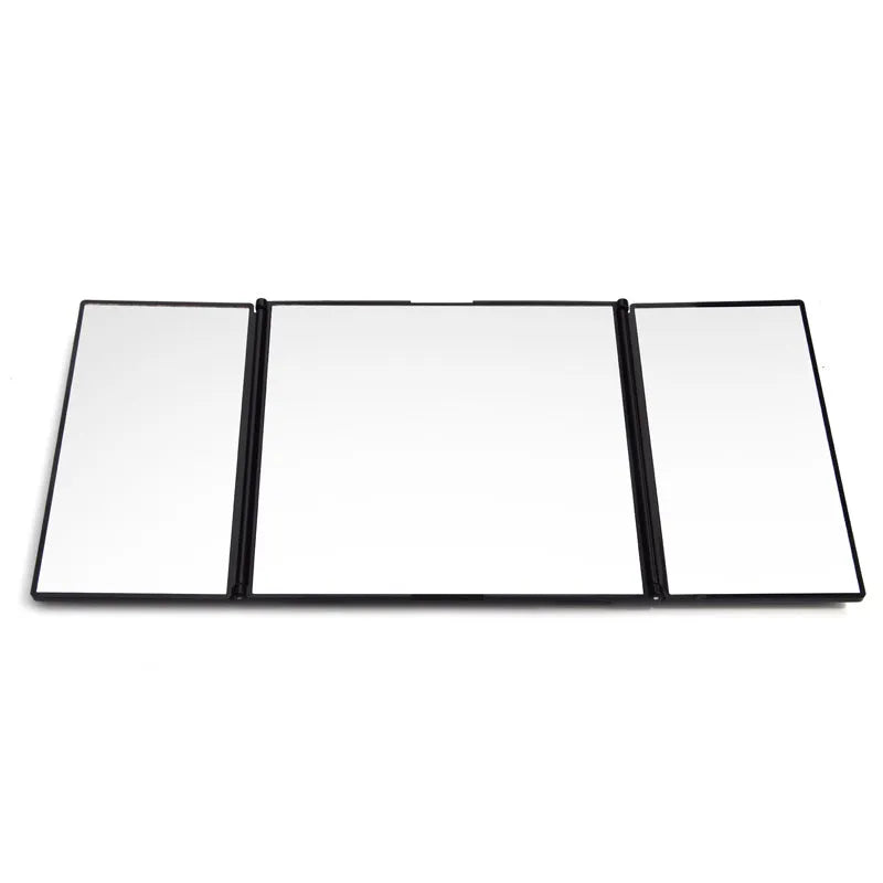 Silver portable car folding mirror shown both closed and opened on a flat surface.