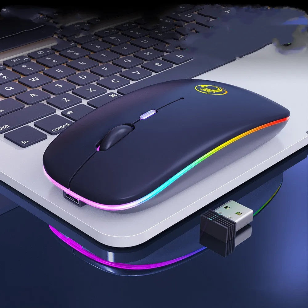 Black and white dual-mode wireless silent mouse with USB charging cable on a desk.
