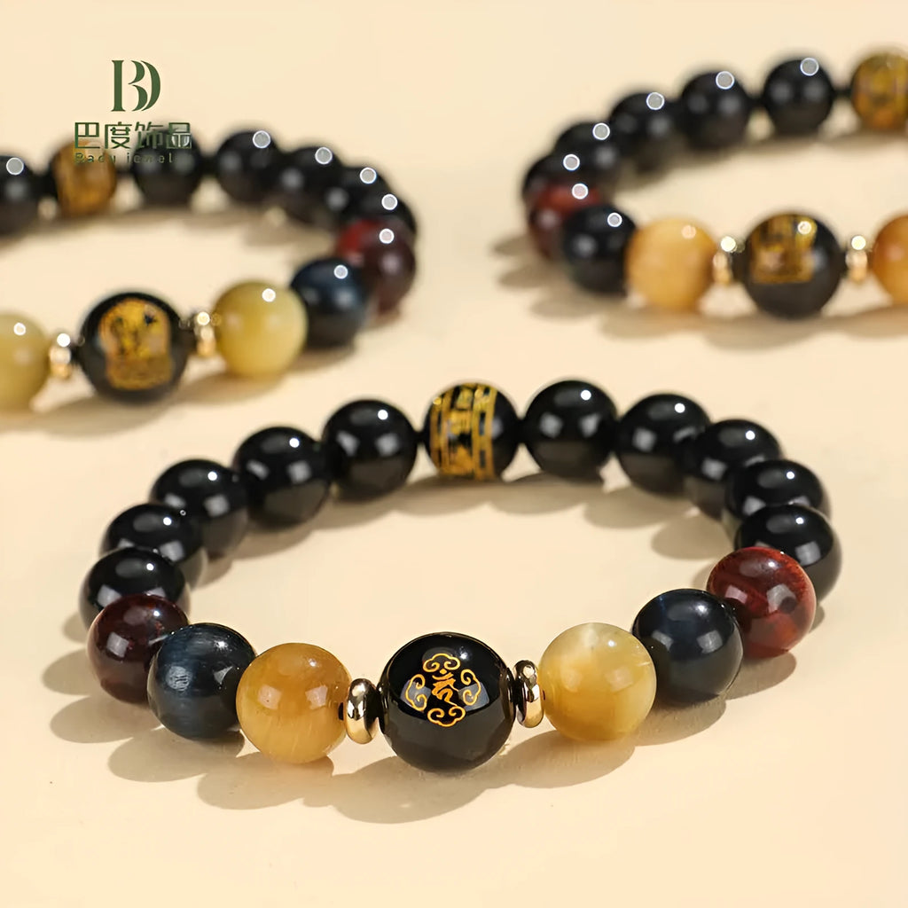 Handmade black agate beaded bracelet with gold, blue, and red tiger eye stones featuring Buddhist deity and zodiac animal motifs.