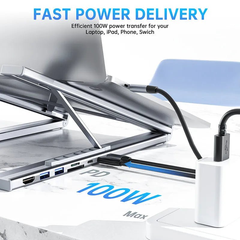 Aluminium folding laptop docking station stand with multi-port hub and HDMI output on a desk