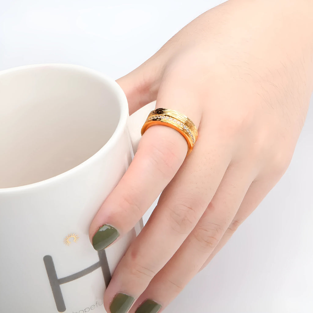 Gold geometric women's zircon ring on a copper base, shown in size 7