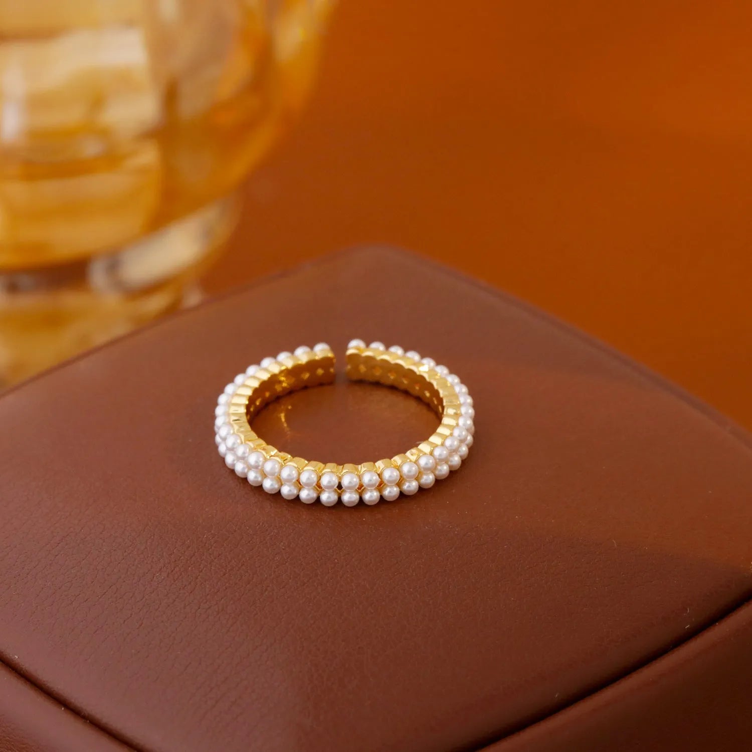 Geometric gold electroplated women's ring with open mouth design and round pearl element