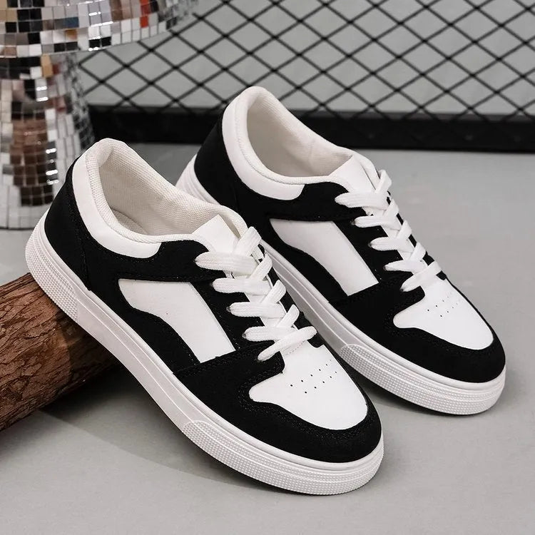 Black women's low-top casual sports shoes with a rubber sole and round toe.