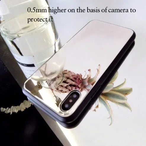 Black iPhone phone case with a built-in circular mirror on the back, shown next to an iPhone.