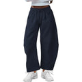 Women's loose cropped sweatpants with elastic drawstring waist in apricot colour showing side pockets and street fashion styling