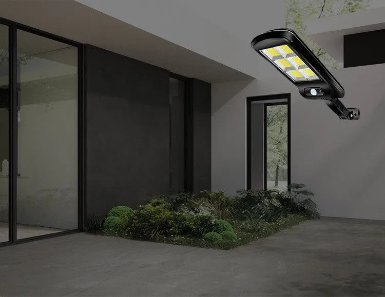 Black solar-powered outdoor wall light with motion sensor for gardens and pathways