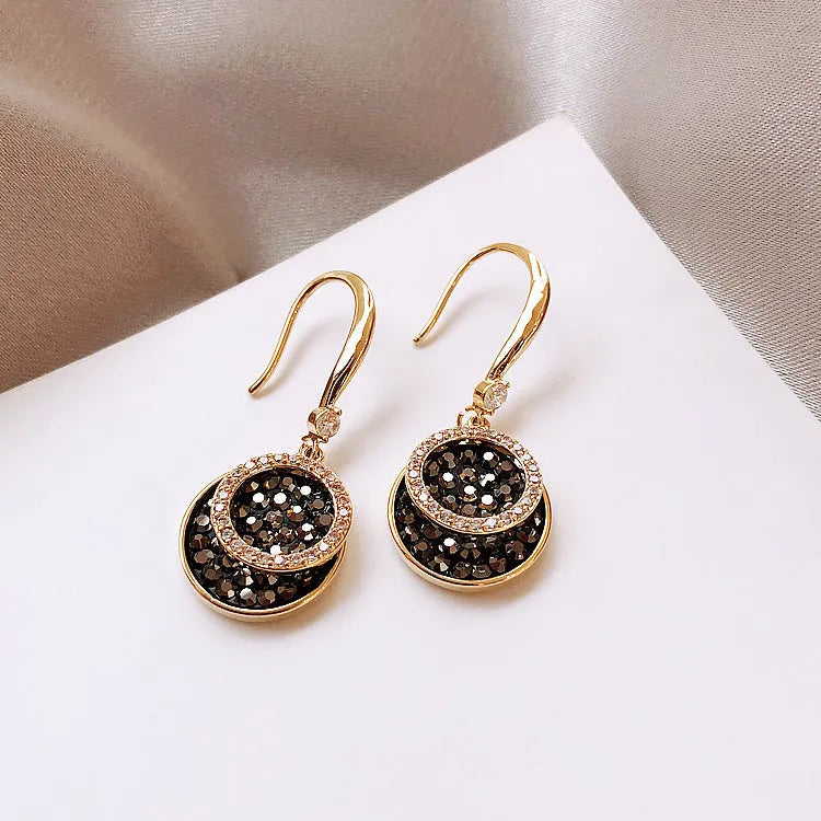 Black geometric alloy drop earrings with round pieces measuring 3.6cm length