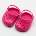 Set of small plastic doll beach slippers in blue, red, yellow, and green colours.