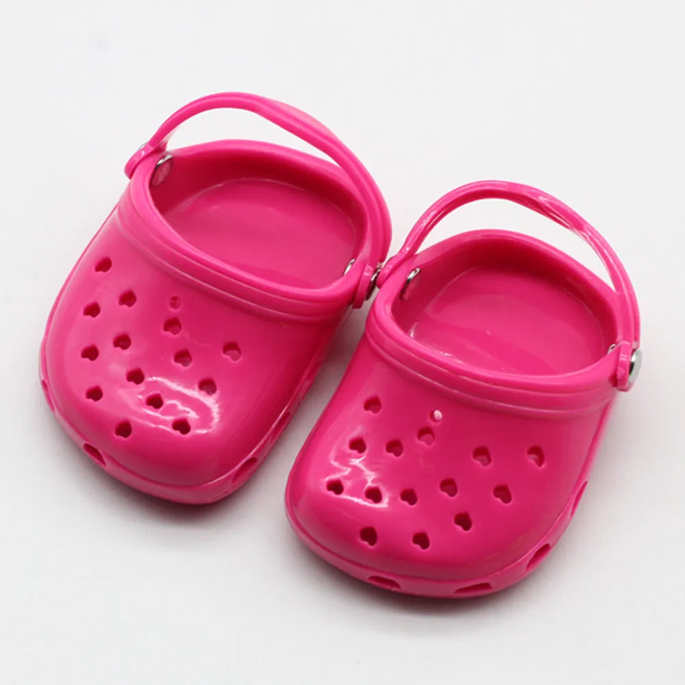 Set of small plastic doll beach slippers in blue, red, yellow, and green colours.