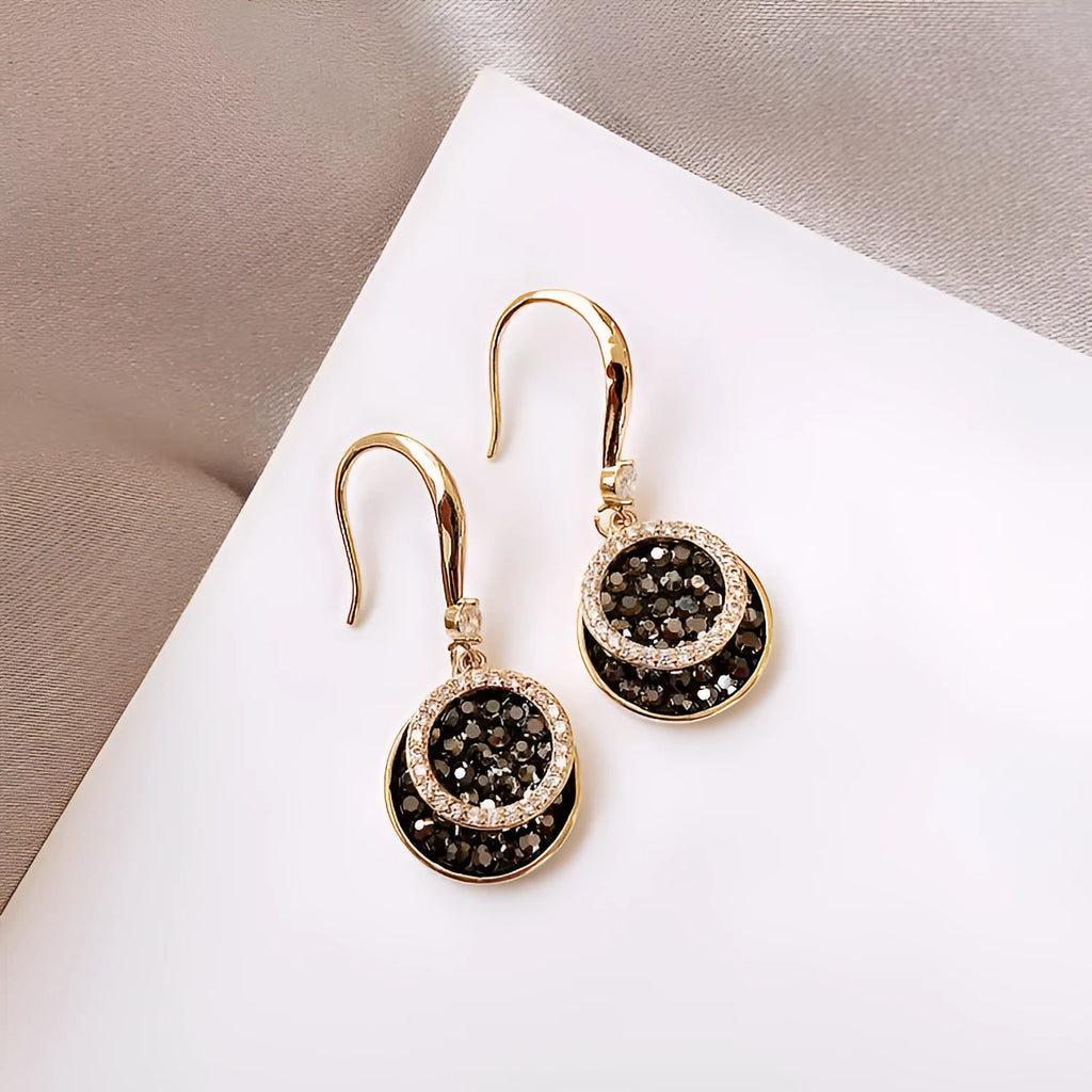 Black geometric alloy drop earrings with round pieces measuring 3.6cm length