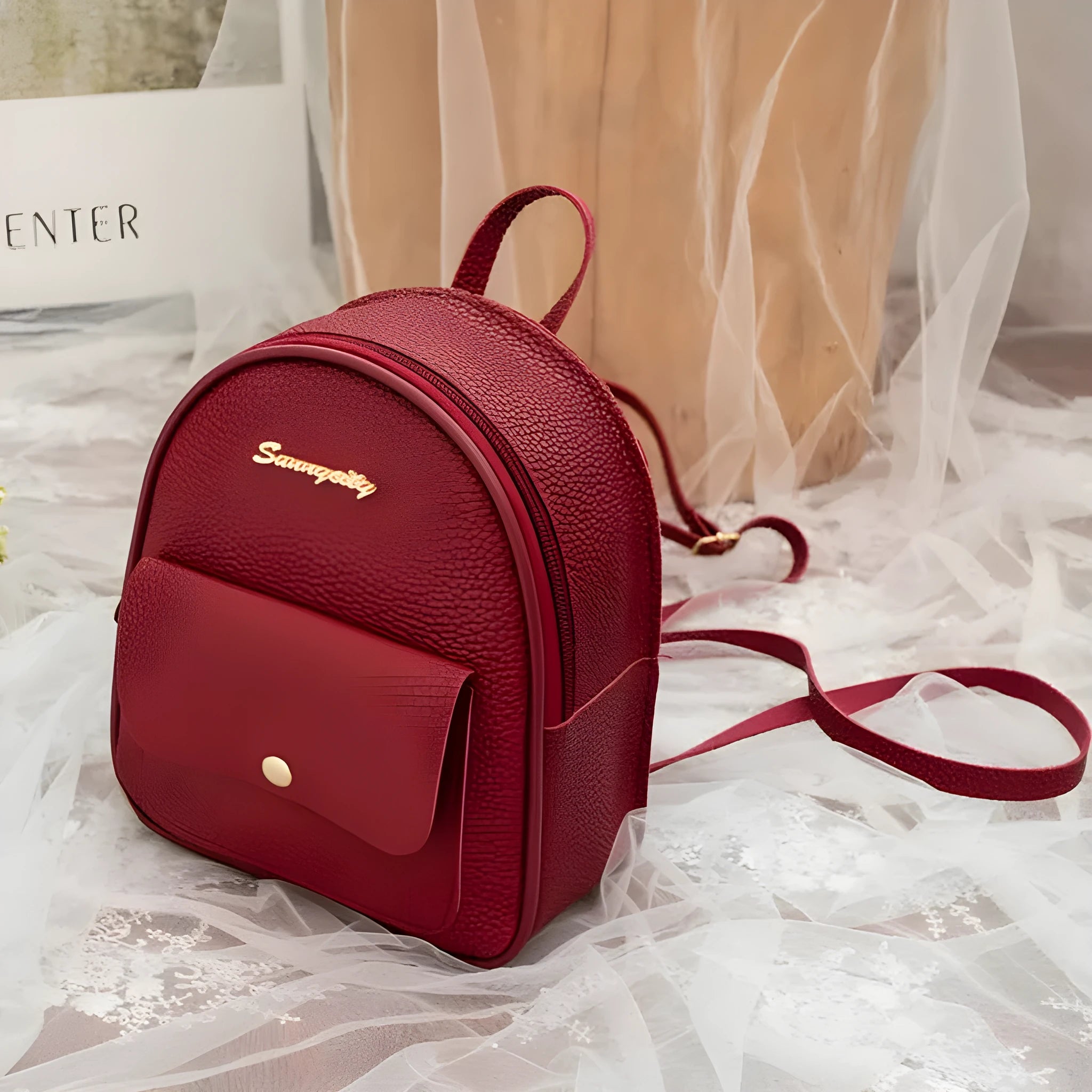 Black PU women's small backpack convertible to a shoulder bag, shown with a mobile phone for scale.