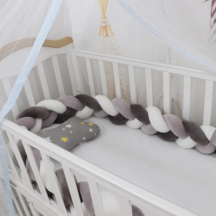 Baby crib bumper protector in spandex velvet, bent to show flexible shape, against a crib rail.