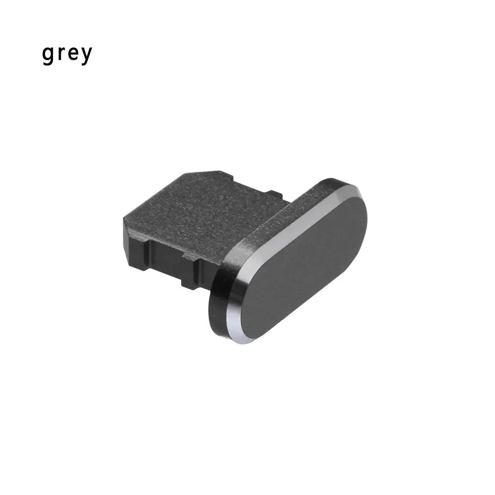 Aluminum alloy iPhone charging port dust plug in rose gold colour on a grey background.