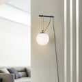 Nordic modern glass wall lamp on a white wall displaying warm white light.