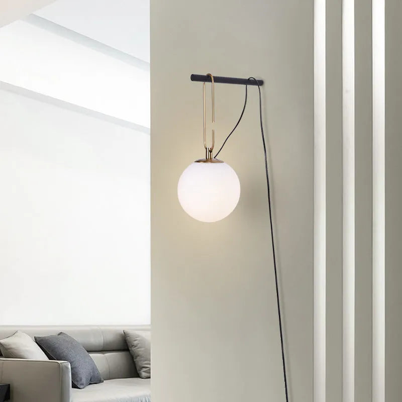 Nordic modern glass wall lamp on a white wall displaying warm white light.