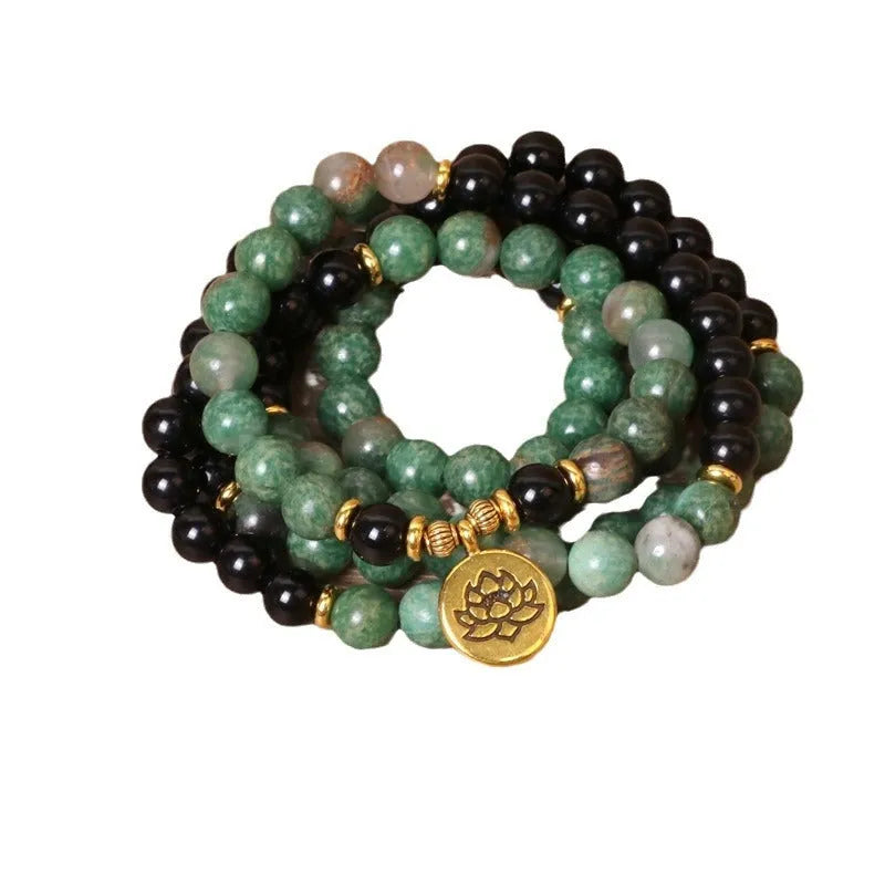 Long elastic bracelet with green and black alloy charms and natural style beads on a stretch band.