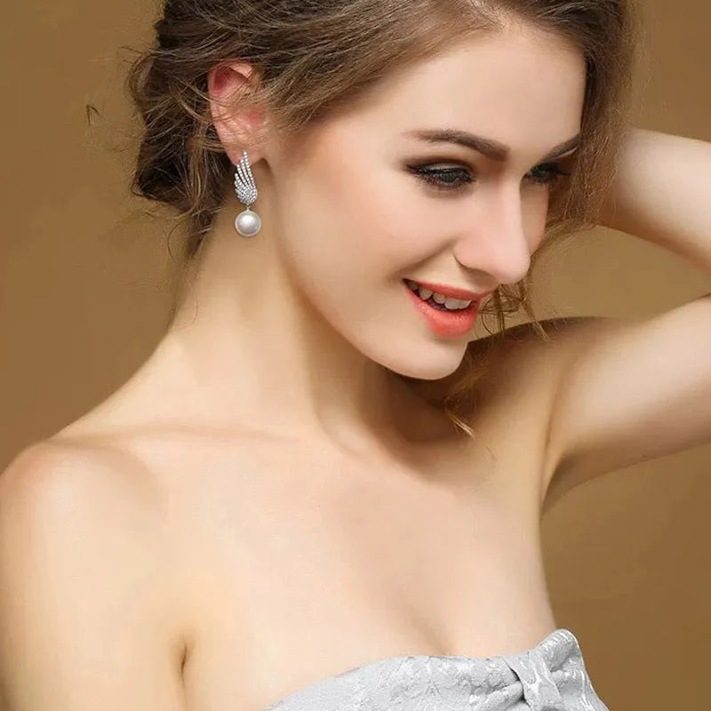 Silver angel wing earrings with diamond treatment and gold-plated gemstone inlay in platinum colour