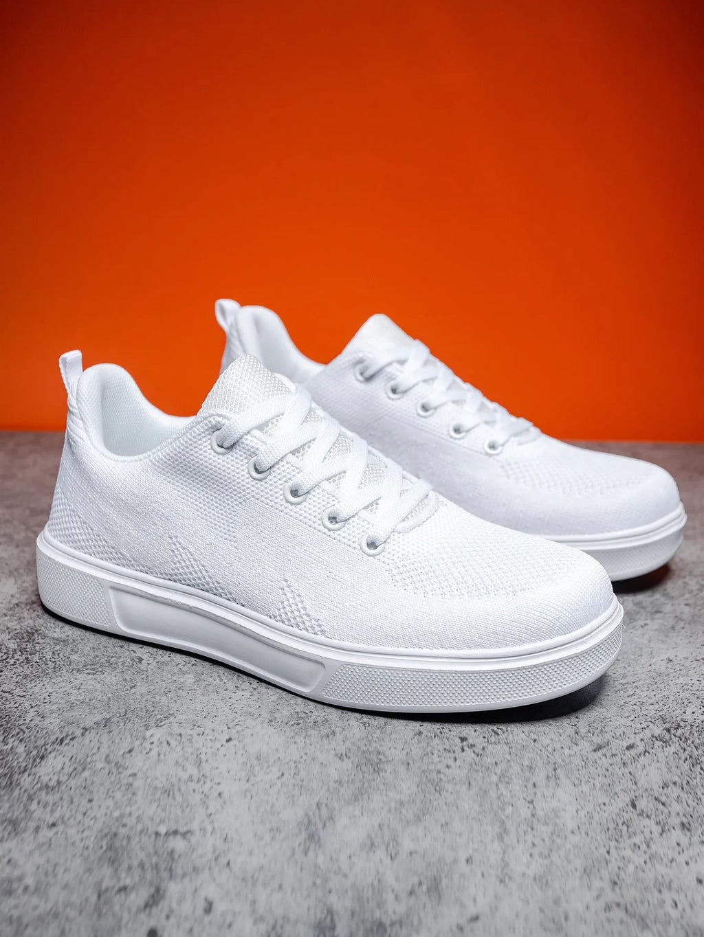 White casual sports shoes with thick EVA sole and mesh upper, flat heel, round toe, front lace-up closure
