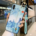 Rose flower design iPhone case with an integrated wrist strap for secure carrying.