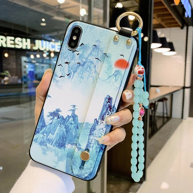 Rose flower design iPhone case with an integrated wrist strap for secure carrying.
