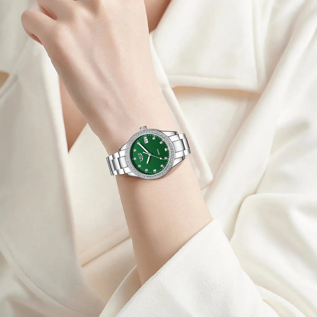 Women's silver fashion watch with diamond bezel, round white dial, luminous hands, and stainless steel bracelet.