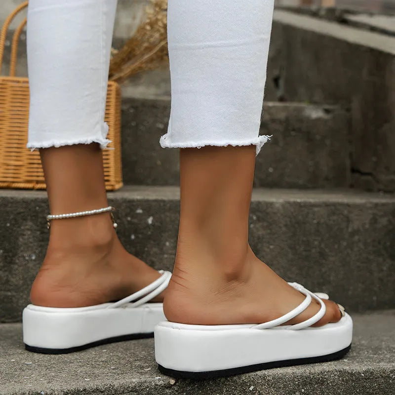 A pair of thick-soled herringbone-style flip-flops in a chosen colour, showing the round toe and rubber bottom.