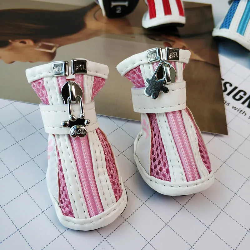 Set of four blue cloth dog shoes with zippers and non-slip soles for small to medium dogs.