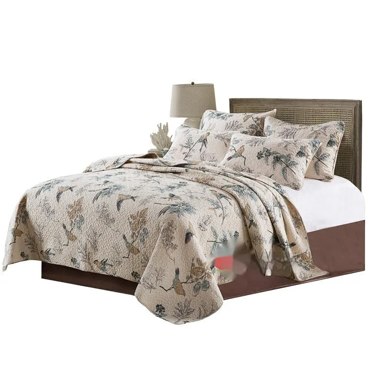 Quilted pure cotton bed cover set with printed pattern on a double bed with matching pillowcases.