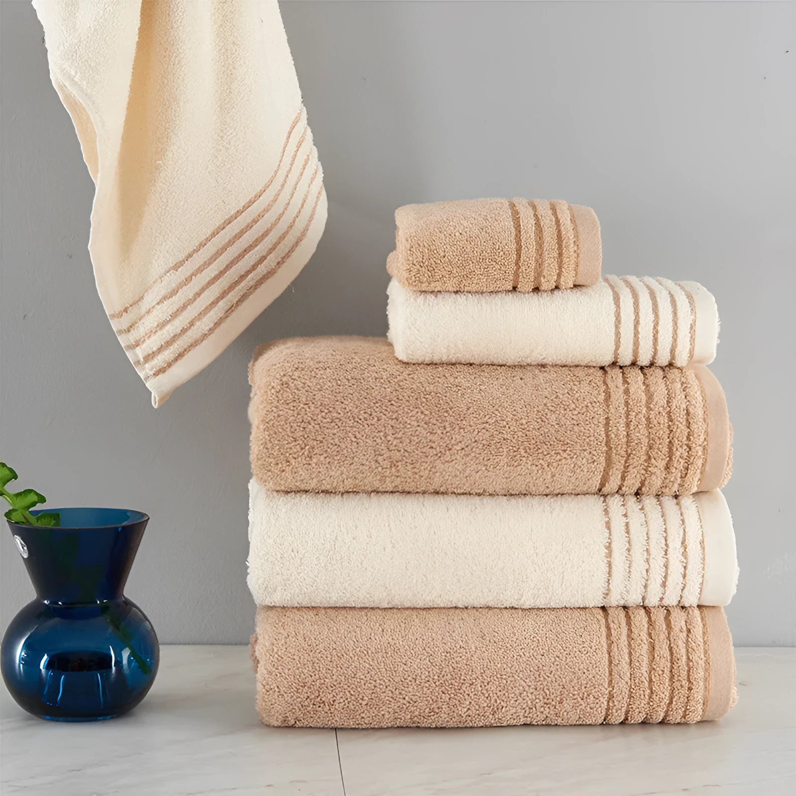 Cotton towel set showing three sizes in beige and brown colours for bathroom use