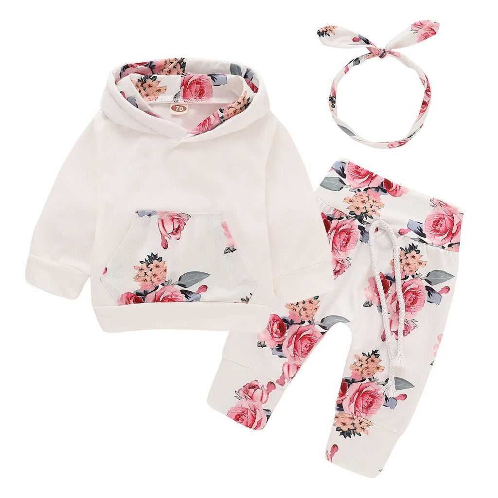 White print hooded romper suit for baby girls made from soft cotton with long sleeves and trousers.