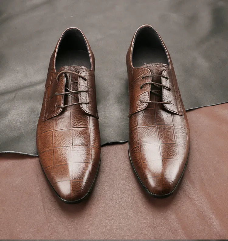 Men's black leather derby shoes with pointed toe and rubber sole on a white background.