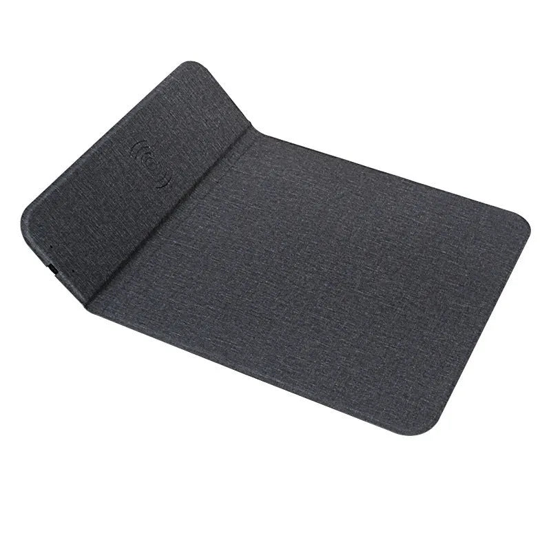Foldable cloth phone holder with built-in wireless charging pad on a desk.
