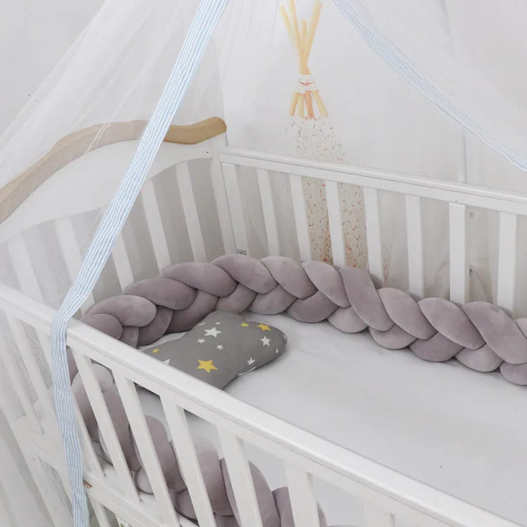 Baby crib bumper protector in spandex velvet, bent to show flexible shape, against a crib rail.