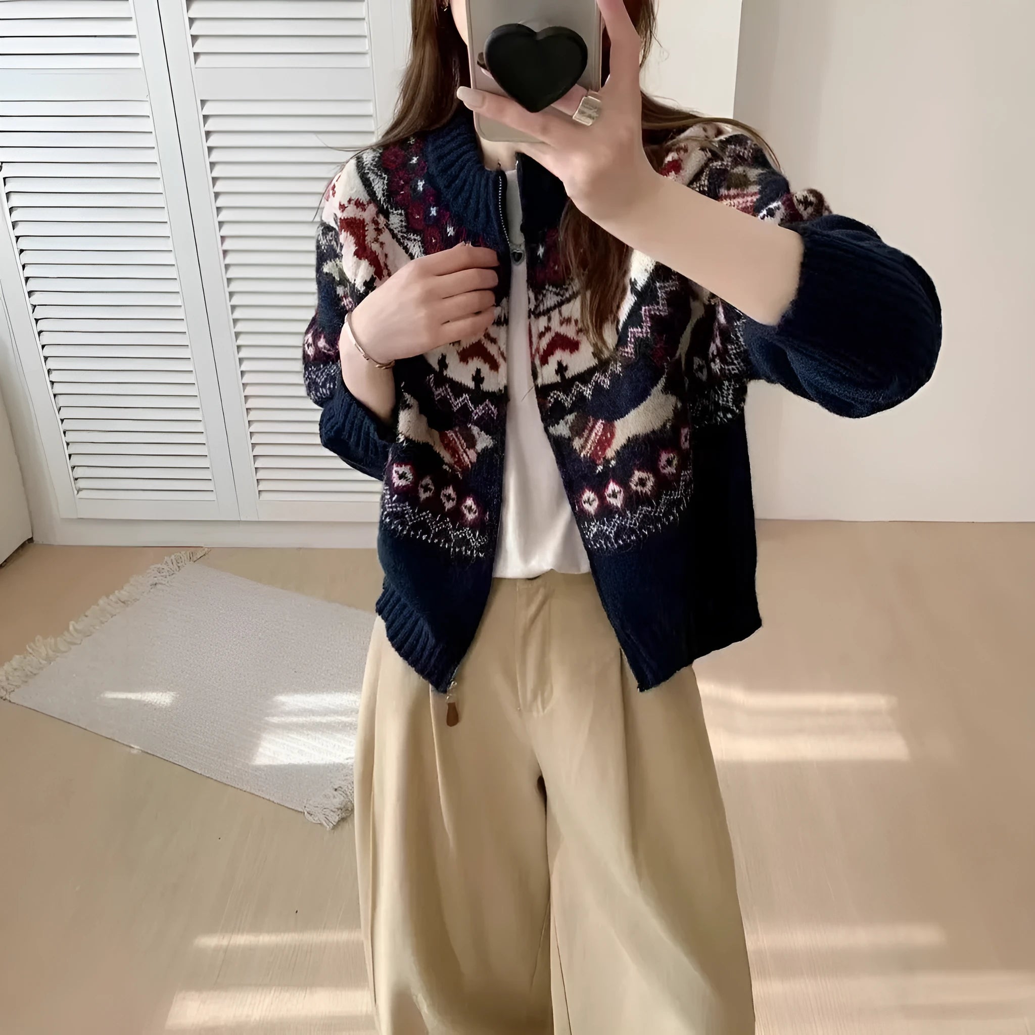 Beige apricot ethnic style jacquard pullover sweater with 3D pattern, round neck, and long sleeves laid flat.