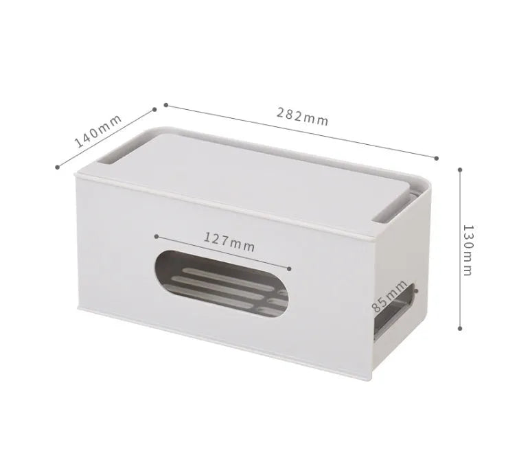 White plastic wireless router storage box with cable slots on a desk next to a router.