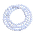 Blue agate bracelet with multi-circle pattern and scattered striped beads on a wrist.