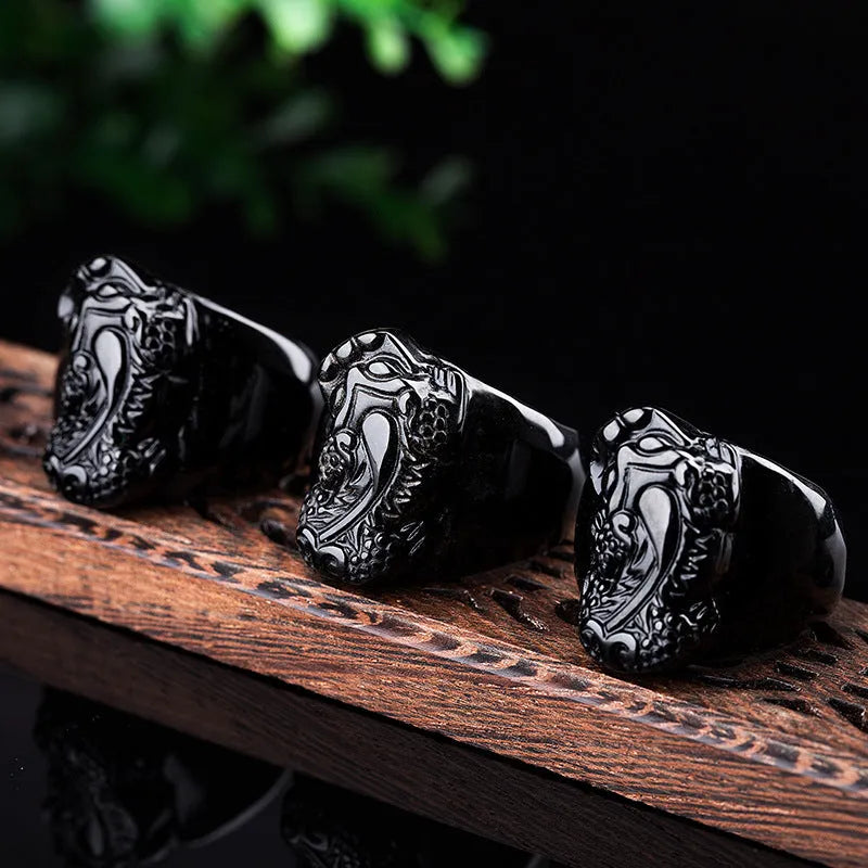 Men's obsidian crystal thumb ring featuring a detailed pixiu carving and a natural gold sheen.