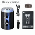 Black portable rechargeable shaver with USB cable and cleaning brush on a white background.