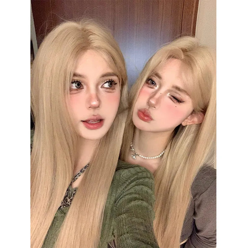 Long straight synthetic wig in milk tea blonde gold colour with hair net on display
