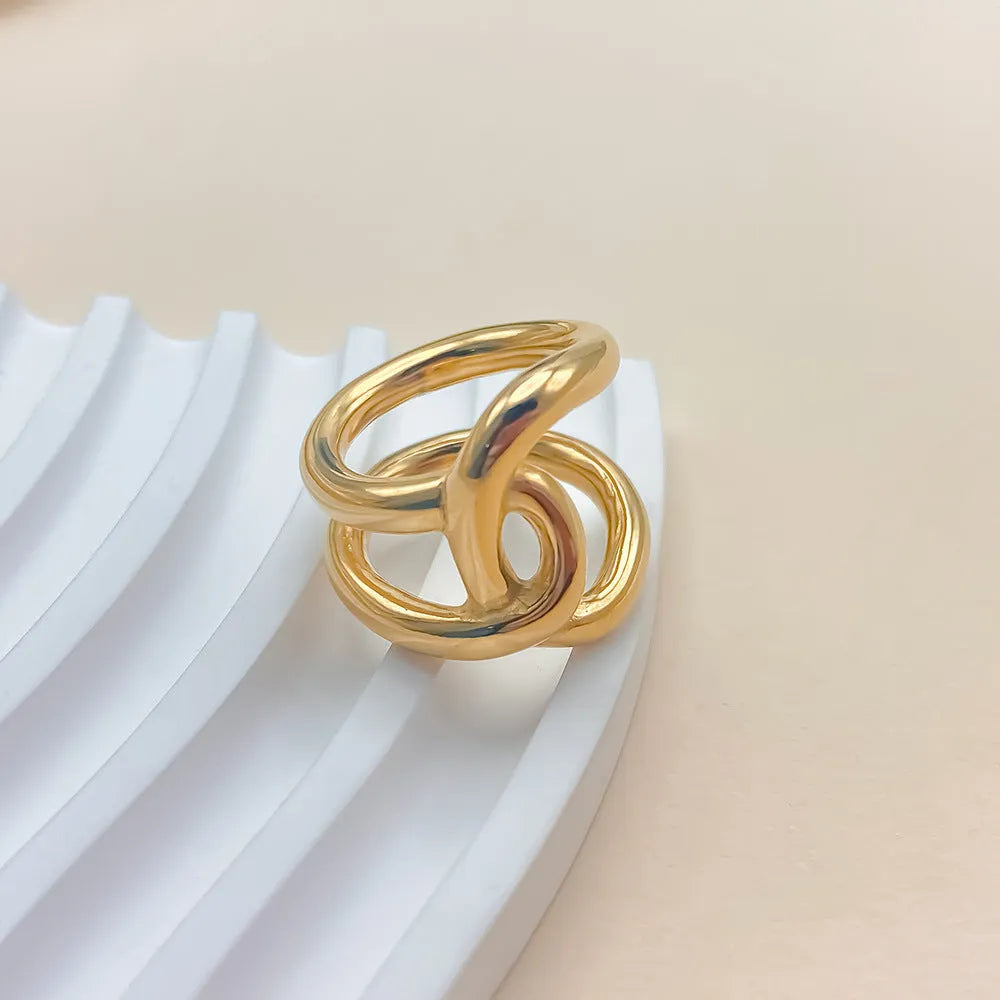 Geometric knotted women's adjustable ring in stainless steel, showing U-shaped opening.