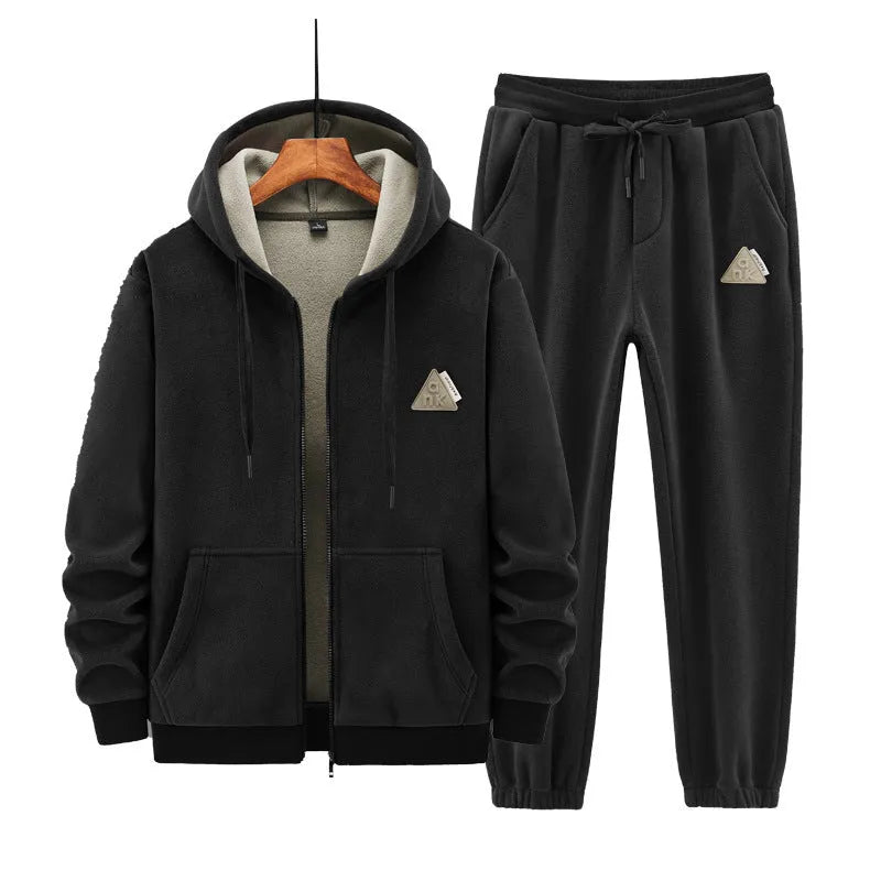 Man wearing a grey cashmere hooded sweater and matching cotton pants from a casual sports suit set.