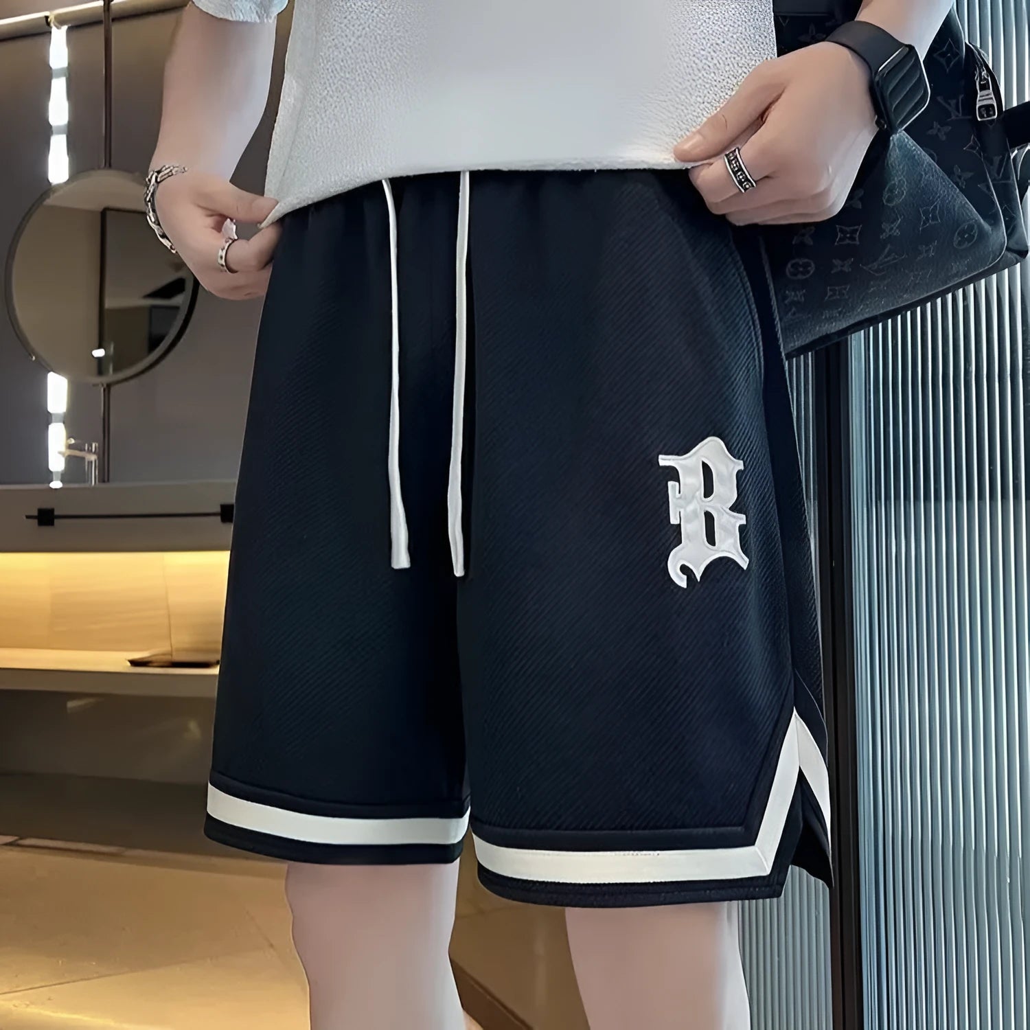 Men's loose straight drawstring sports shorts in solid colour with wide leg and low waist on plain background