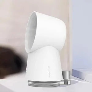 White desktop bladeless fan with USB power and humidification spray on a desk