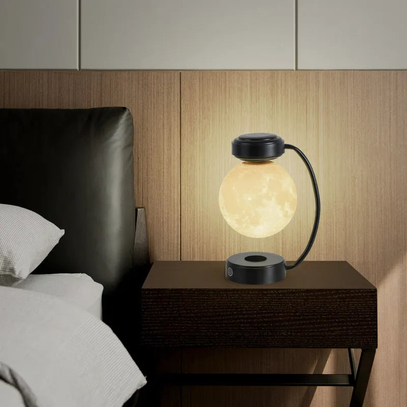 3D LED moon night light with magnetic levitation, floating ball, iron base, black finish on a desk