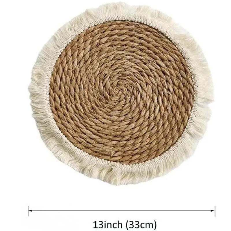Round natural papyrus placemat on a wooden table, showing corn rope tassel detail and modern minimalist style.
