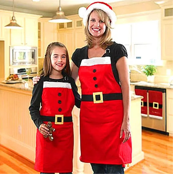 Red Christmas apron with 'Merry Christmas' text for adults and children in kitchen setting